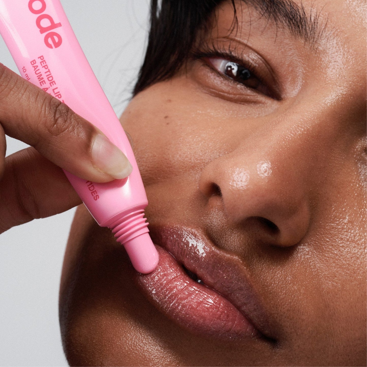 model wearing peptide lip tint jelly bean