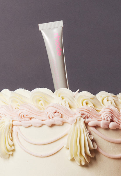 peptide lip treatment stuck on top of a vanilla cake