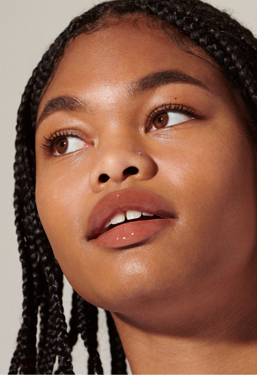 Model with glossy, tinted lips - wearing Toast Lip Tint