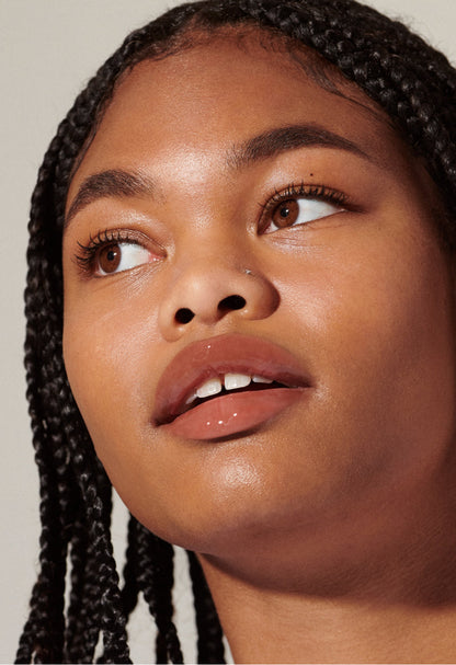 Model with glossy, tinted lips - wearing Toast Lip Tint