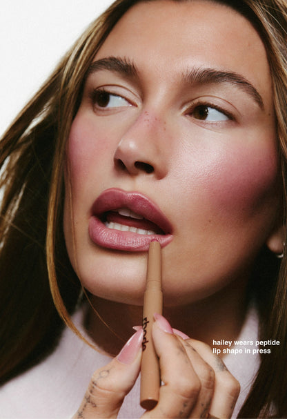 hailey wears peptide lip shape in press