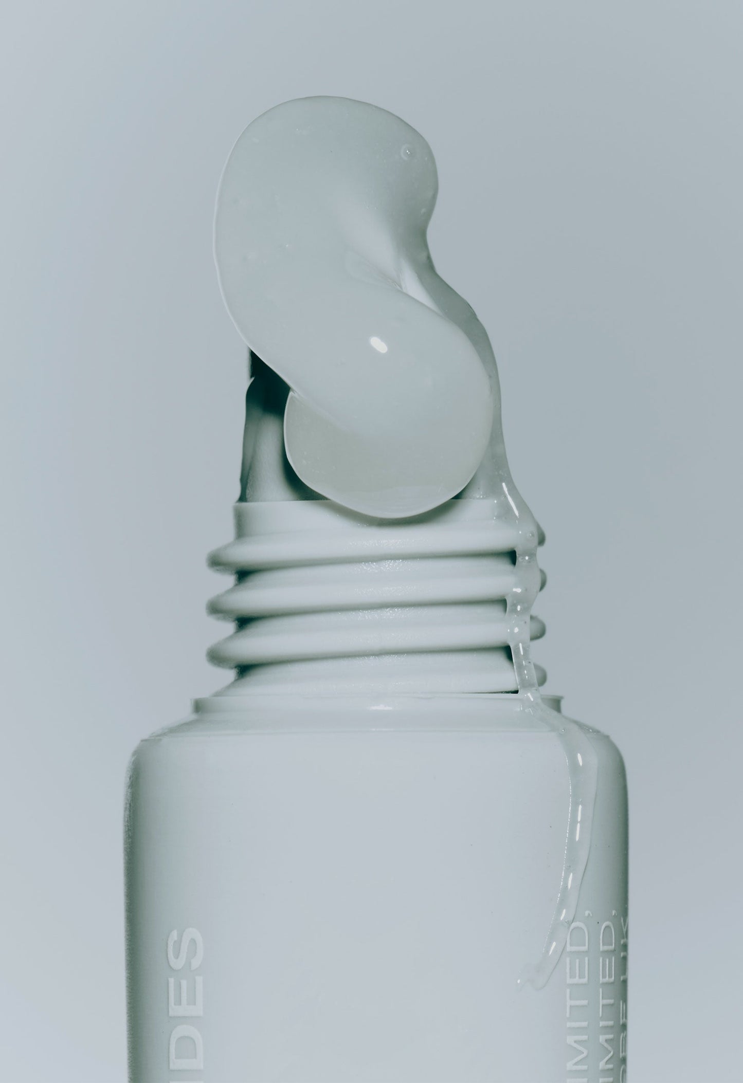 closeup of rhode peptide lip treatment (unscented) with product squeezing out